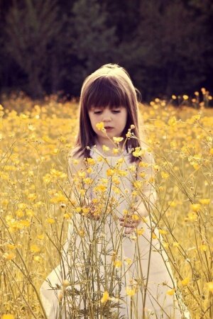 Cute Child In A Flower Field Mobile Wallpaper